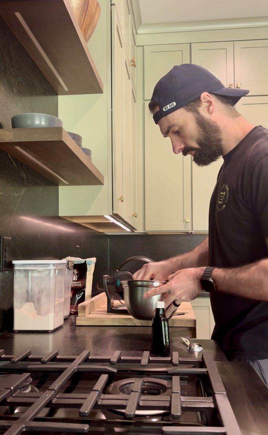 Blake in the kitchen, mixing batter at the stove